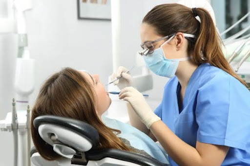 dentist performs dental procedure with the aid of local anesthesia