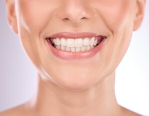 Healthy, confident smile showcasing cosmetic dentistry and porcelain veneers.